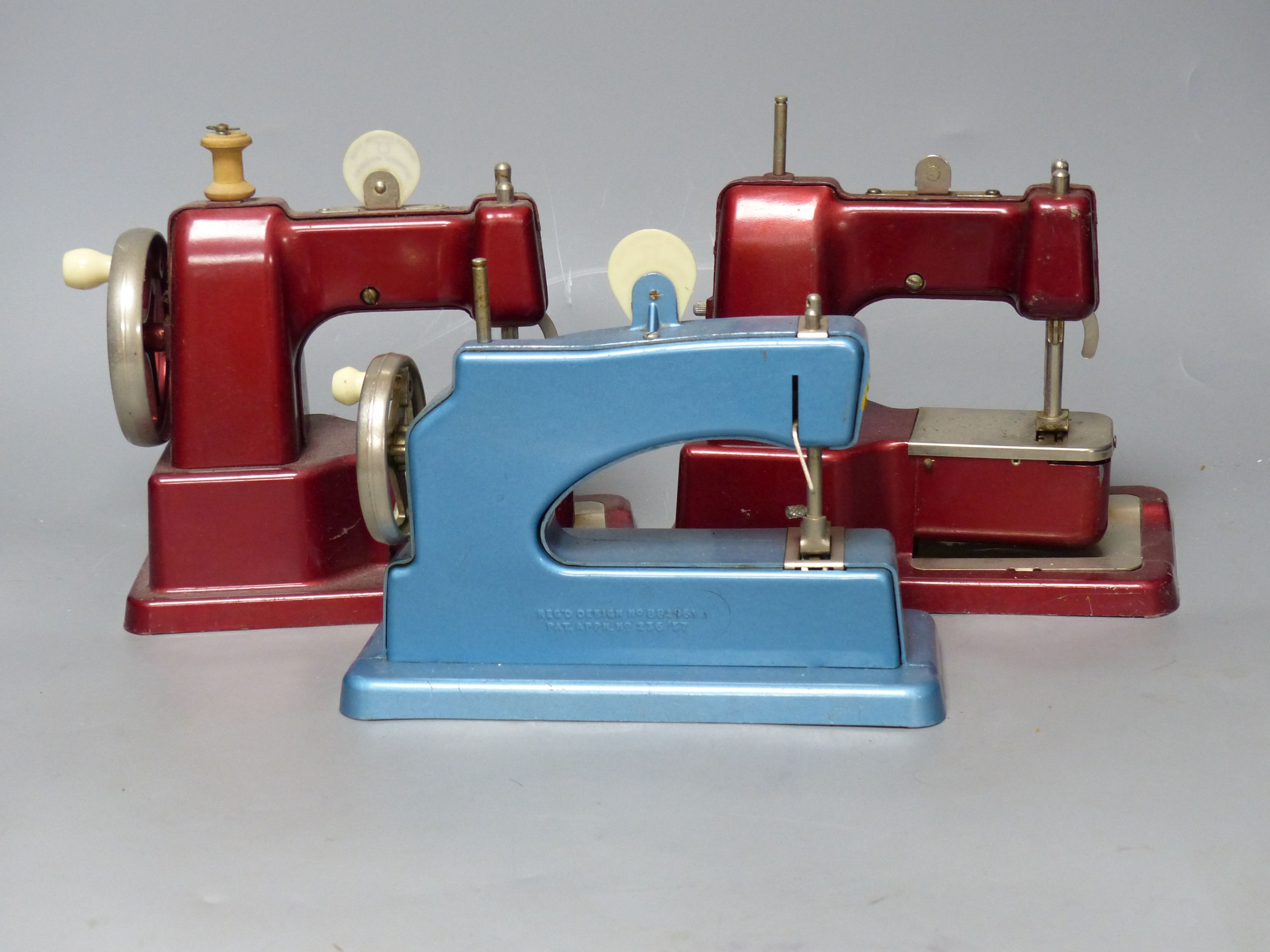 Three vintage hand sewing machines